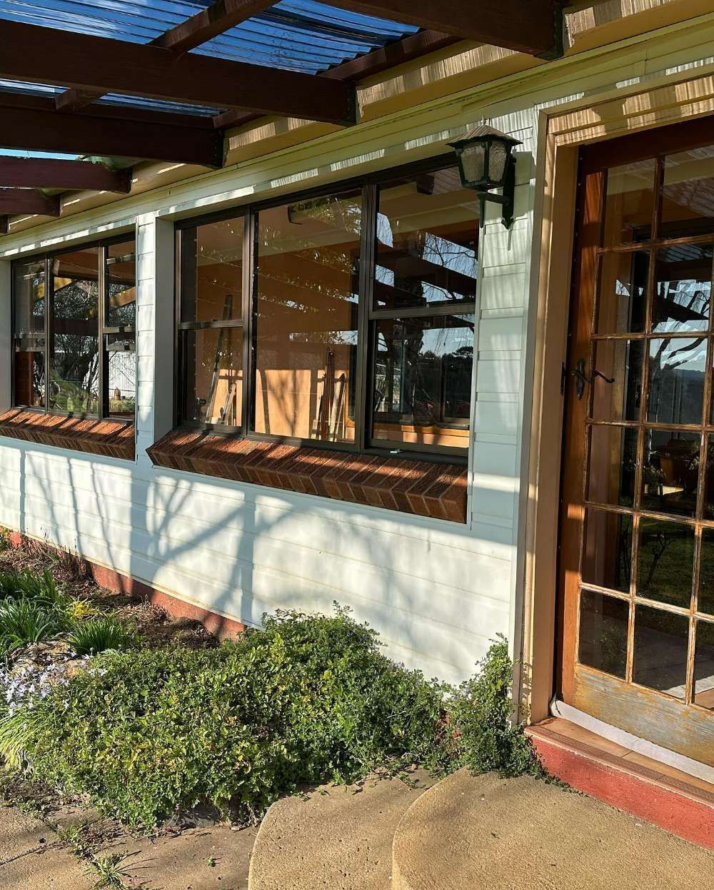 A House With a Lot of Windows and a Door — Pool Fencing, Security Doors, Windows & Shower Screens in Goulburn, NSW