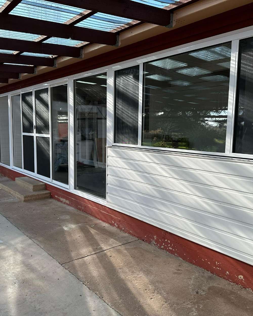 A House With a Lot of Windows and a Clear Roof — Pool Fencing, Security Doors, Windows & Shower Screens in Goulburn, NSW