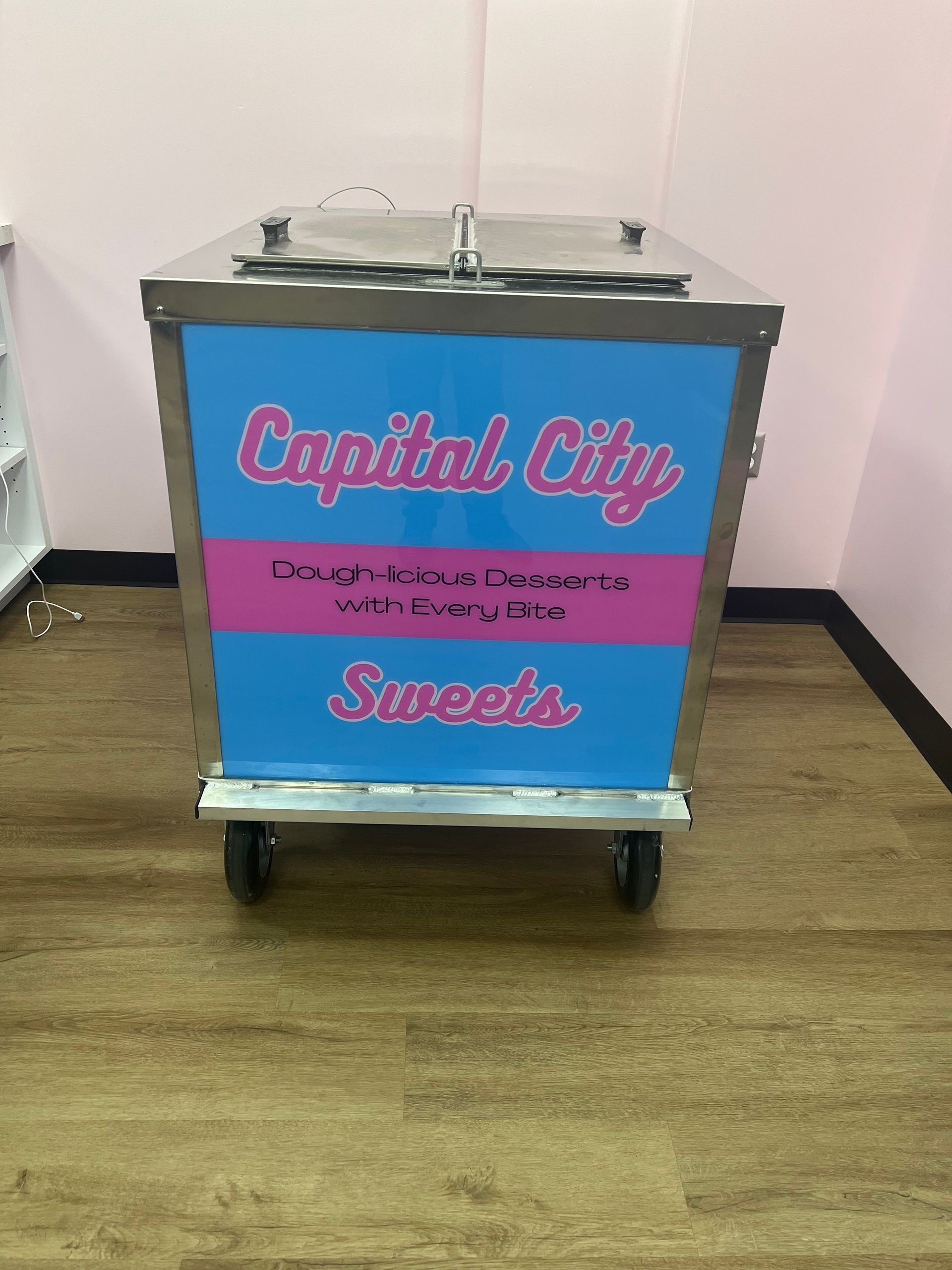 A cart that says capital city sweets on it