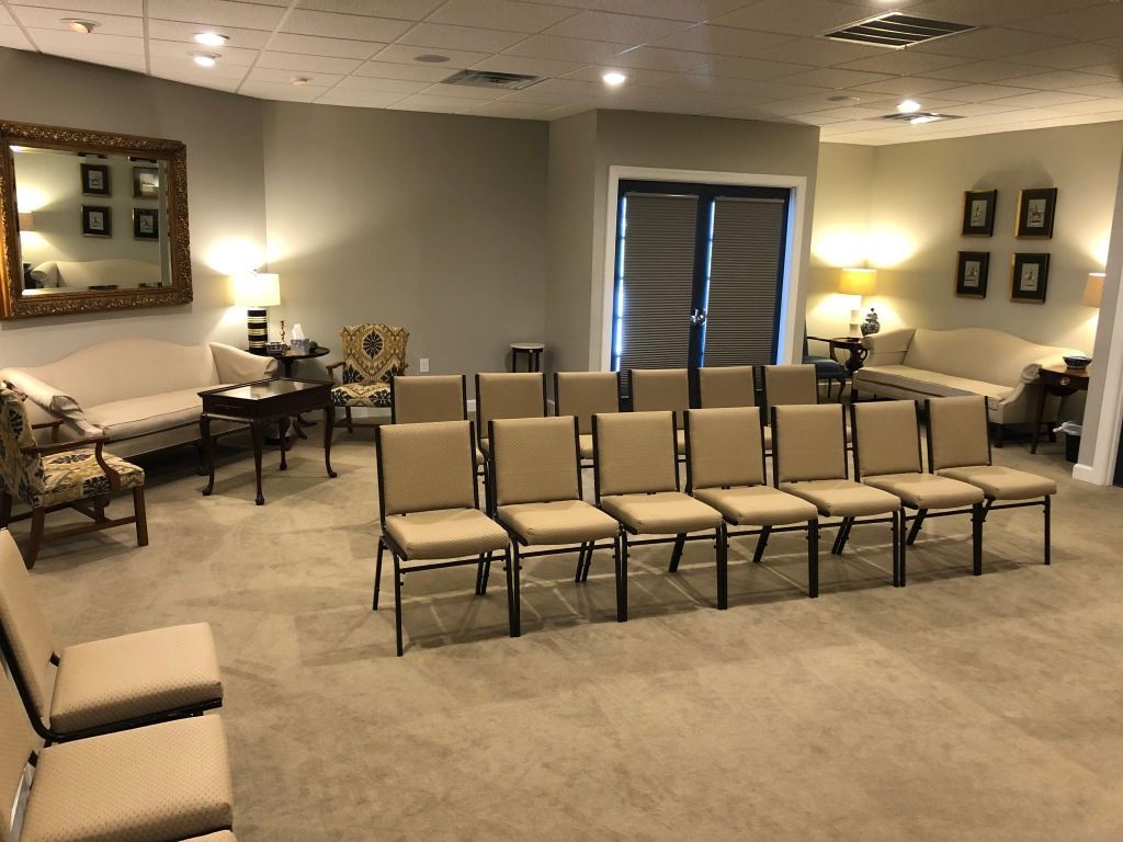 A room with a lot of chairs and a couch