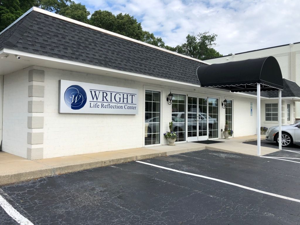 A white building with a sign that says wright on it