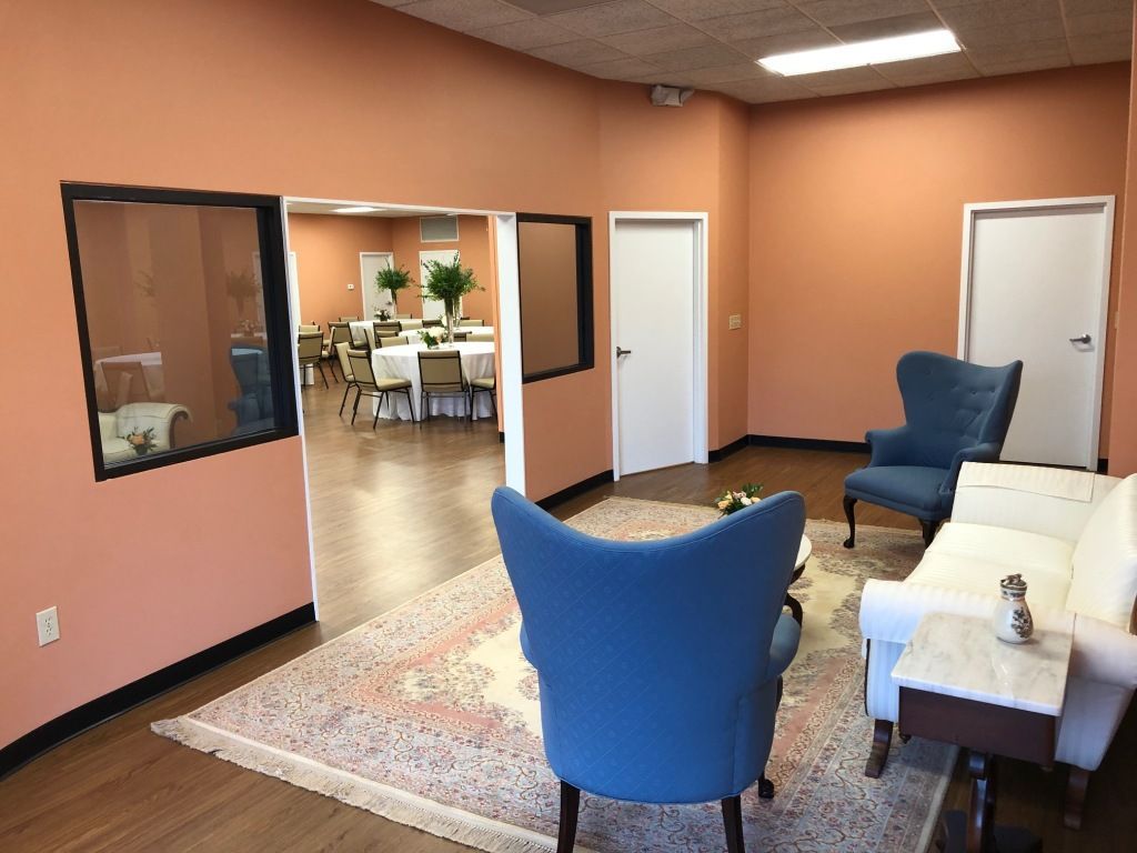 A living room with two blue chairs and a white couch.
