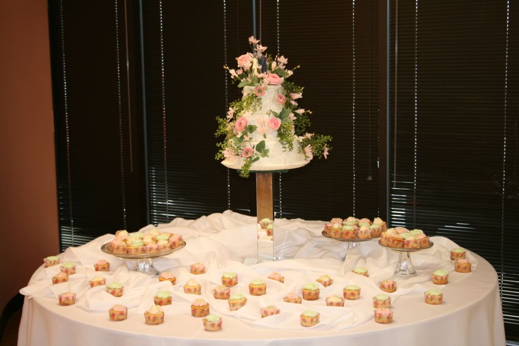 A table with a cake and cupcakes on it