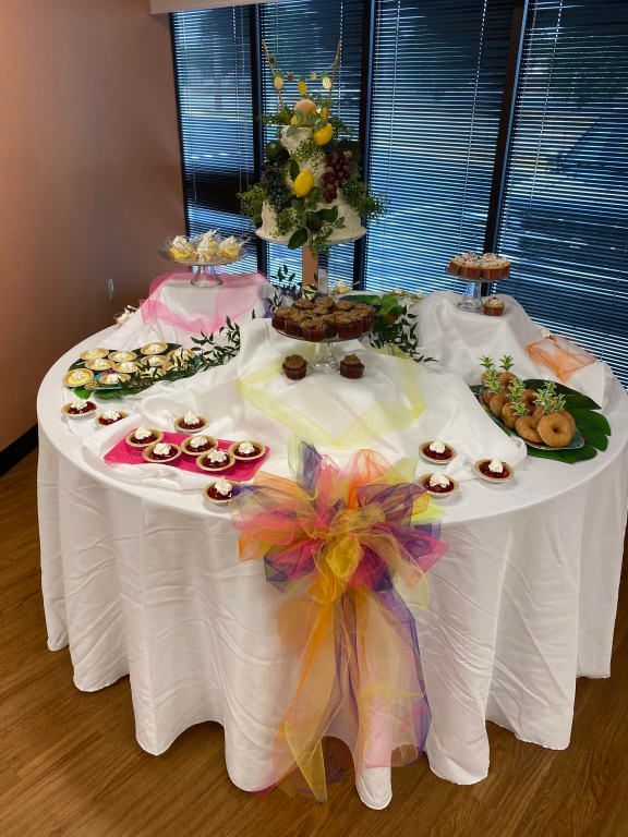 A table with a white table cloth and a bunch of food on it