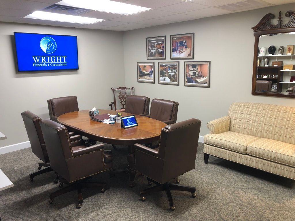 A conference room with a table and chairs and a couch.