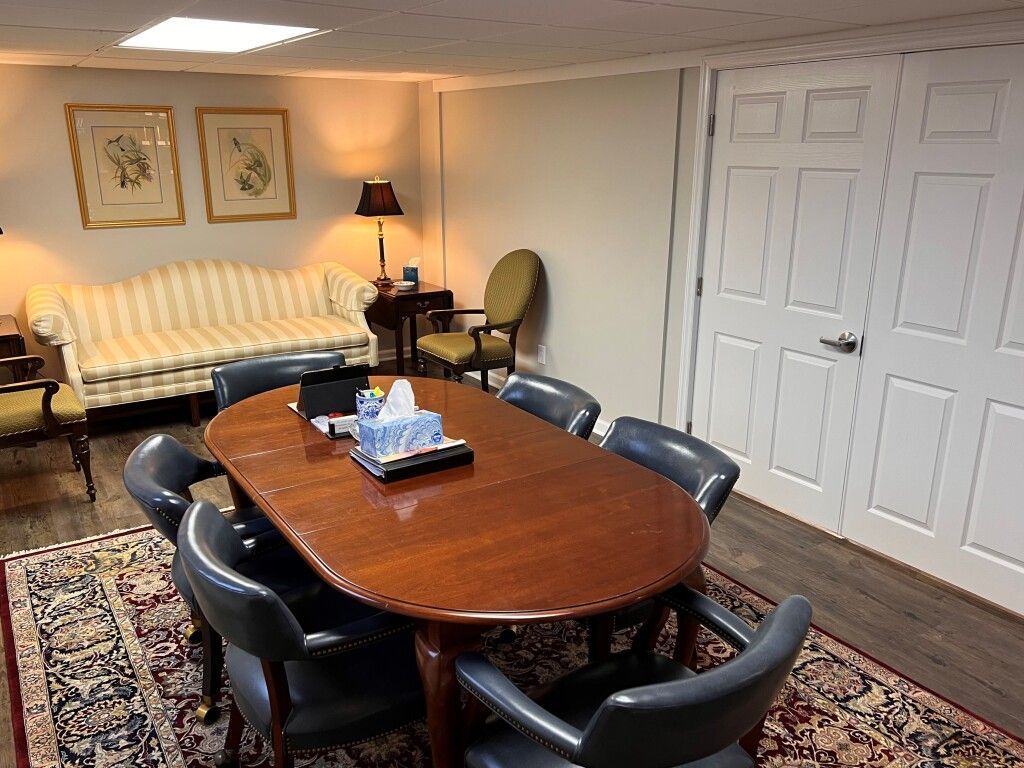 A room with a table and chairs and a couch.