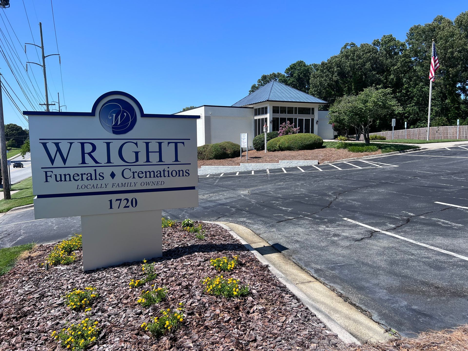 A sign for wright funerals and cremations is in front of a building.