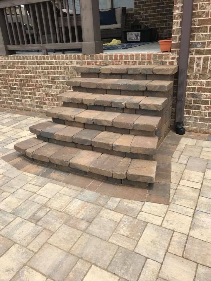 new stone steps and patio leading up to deck
