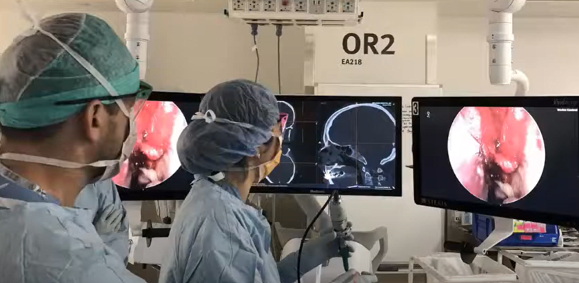 Two surgeons are operating on a patient in an operating room.