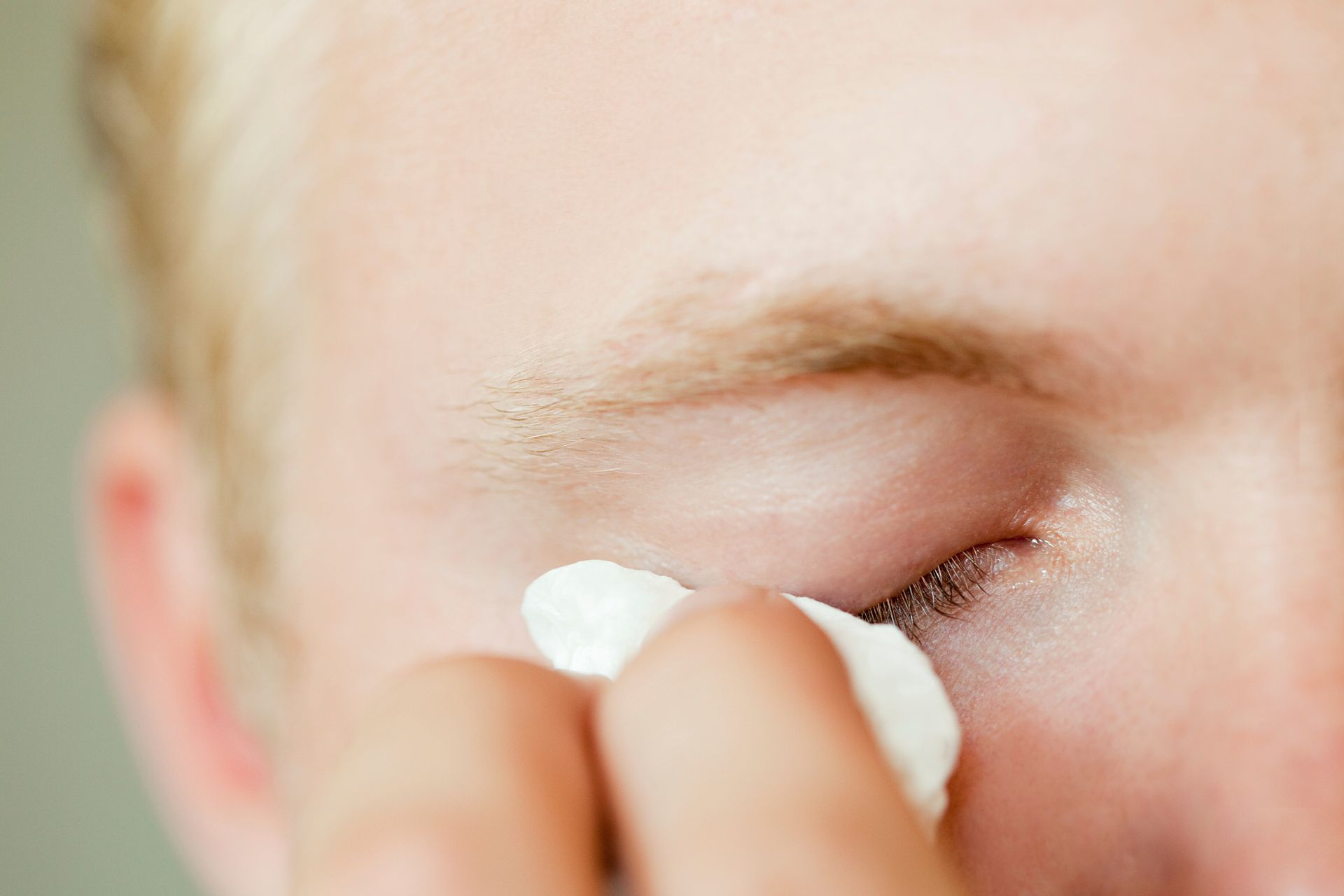 closeup-of-a-person-wiping-away-tears-due-to-blocked-tear-duct