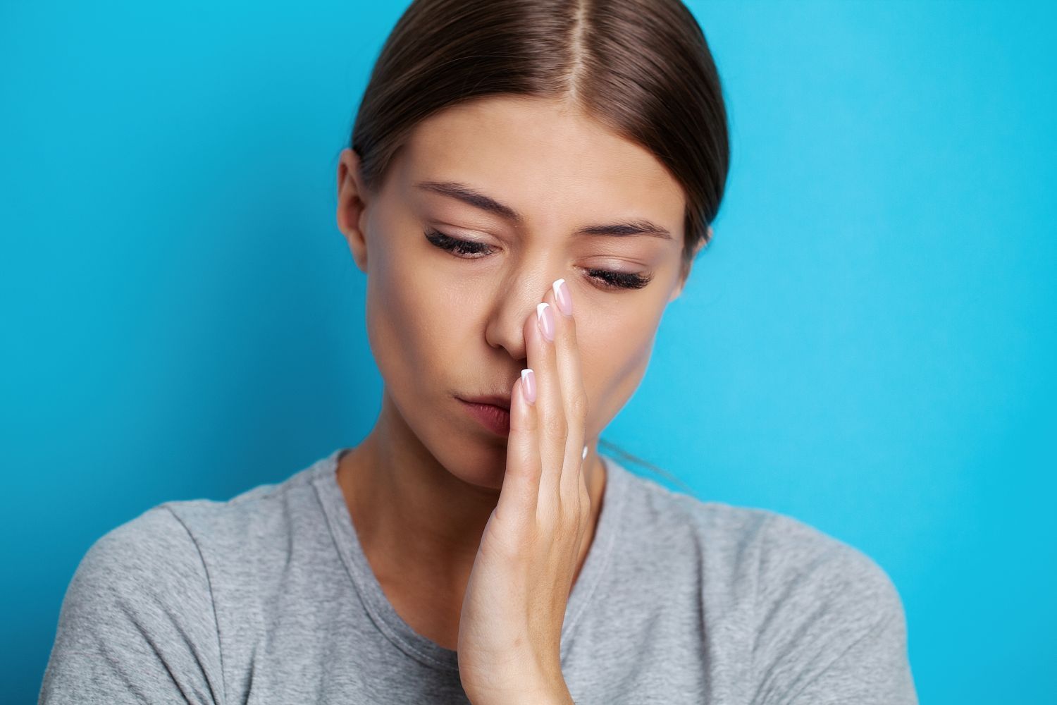 woman-suffering-from-sinus-infection-and-tooth-pain-and-touching-cheek