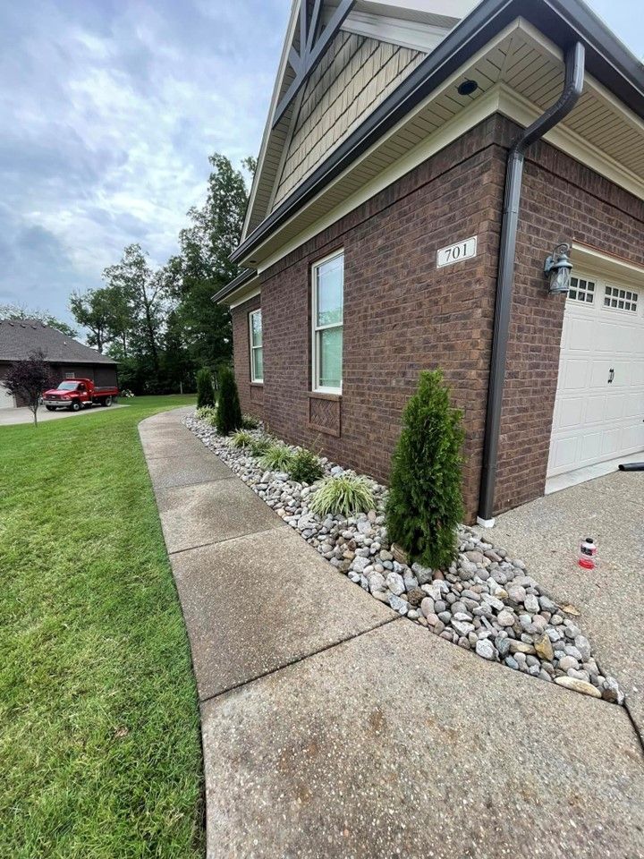 A brick house with a white garage door and a sidewalk in front of it – Mt. Washington, KY - Beck’s