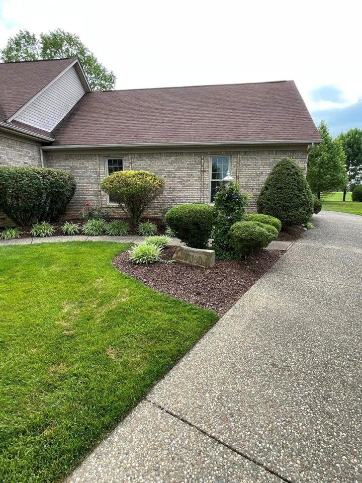 A brick house with a lush green lawn and a driveway leading to it – Mt. Washington, KY - Beck’s