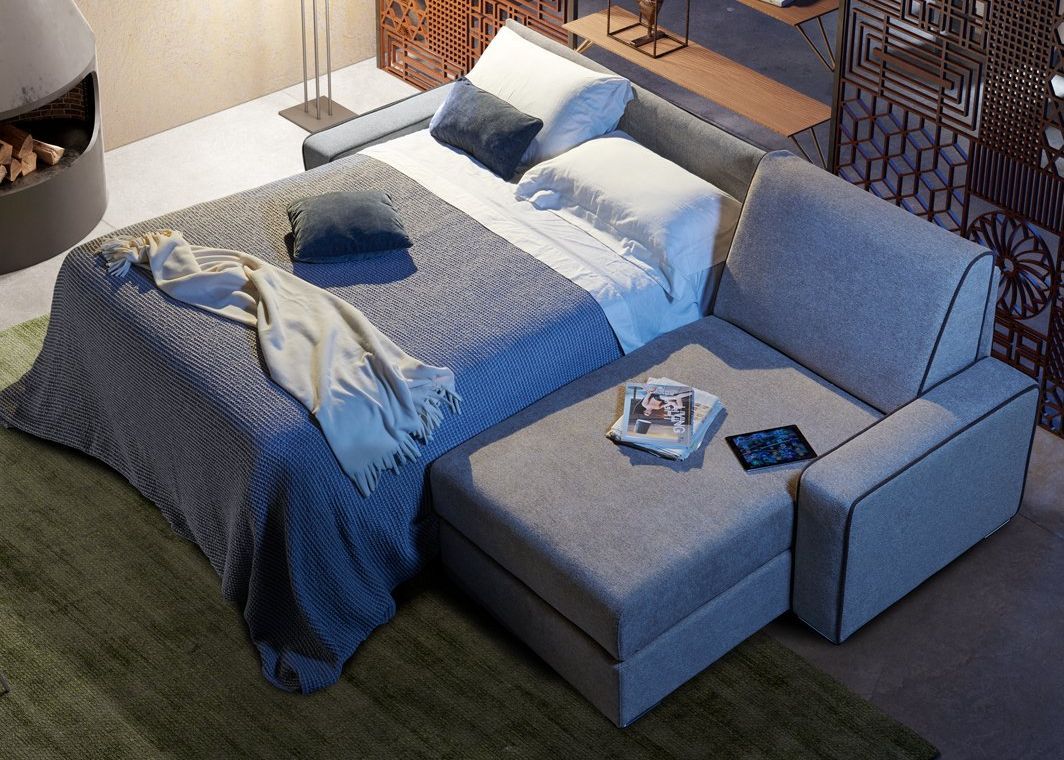 divano letto papeete grigio aperto con bordini a contrasto e penisola ad angolo da tronu arredamenti a cagliari