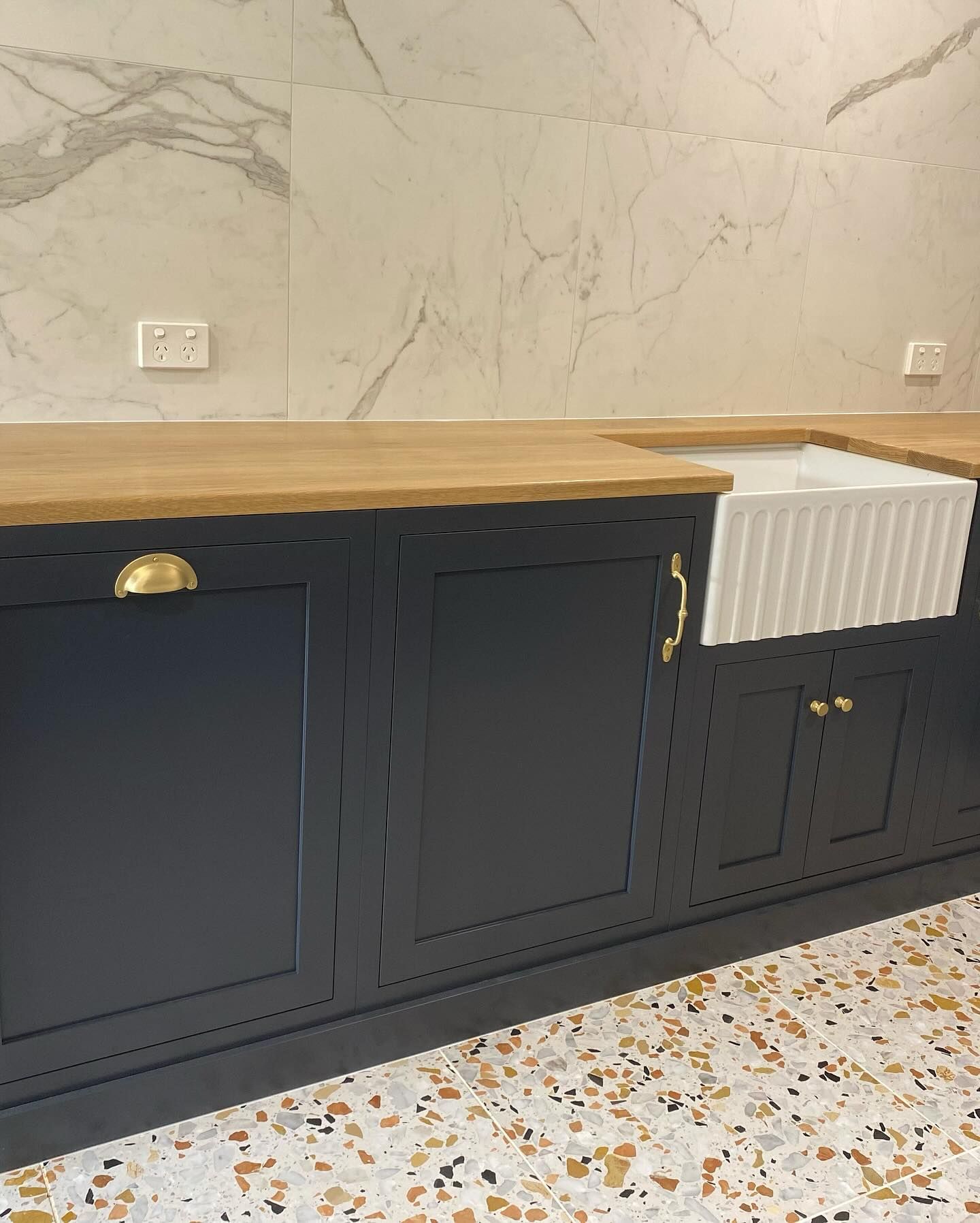 Dark gray kitchen cabinets with gold hardware and a white farmhouse sink — BC Customs in Burrell Creek, NSW