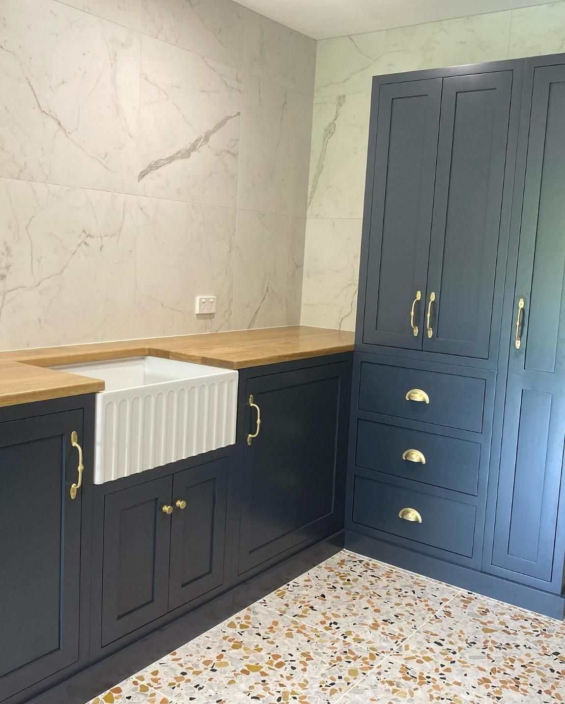 Dark blue kitchen cabinets with gold hardware, white farmhouse sink — BC Customs in Burrell Creek, NSW