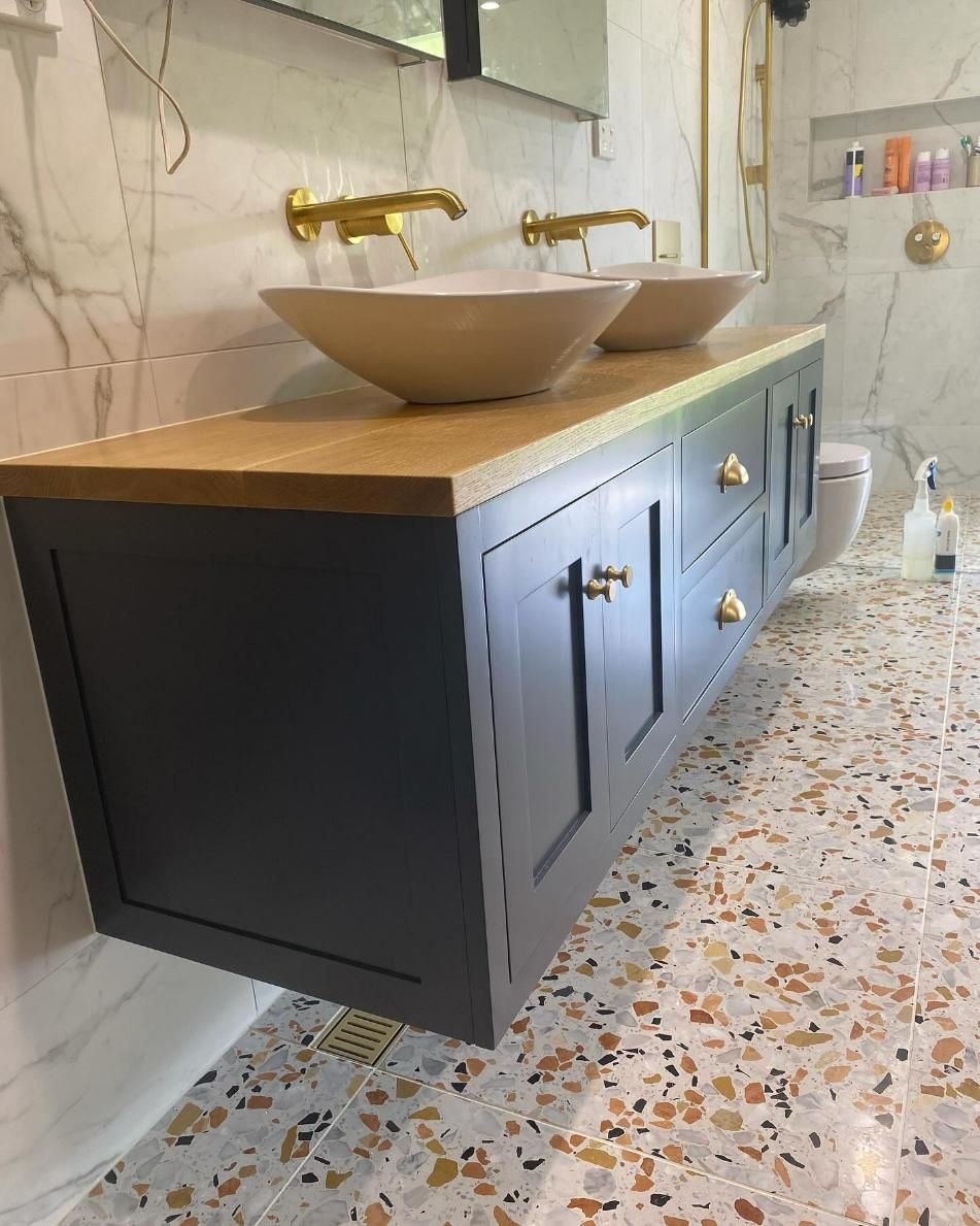 Gray floating bathroom vanity with wood countertop, gold fixtures — BC Customs in Burrell Creek, NSW