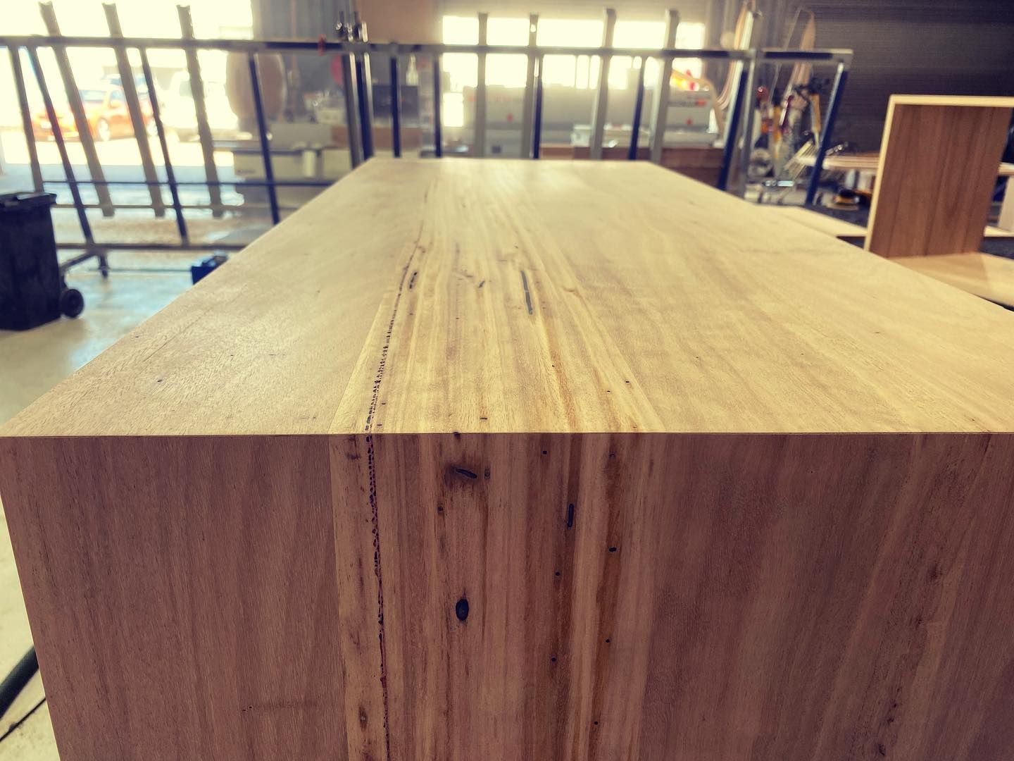Close-Up Of Light Brown Wooden Table In Workshop With Visible Wood Grain And Dark Spots — BC Customs in Central Coast, NSW