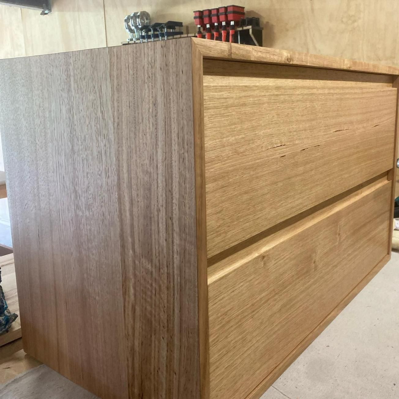 Wooden Two-Drawer Cabinet In Workshop, Light Brown With Visible Wood Grain — BC Customs in Port Macquarie, NSW