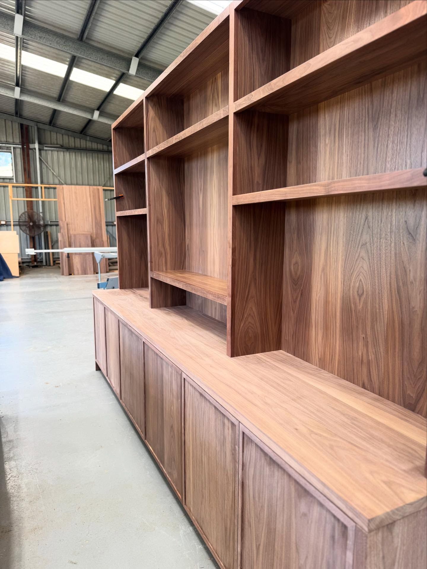 Wooden bookshelf unit in a workshop, featuring shelves and cabinets — BC Customs in Burrell Creek, NSW