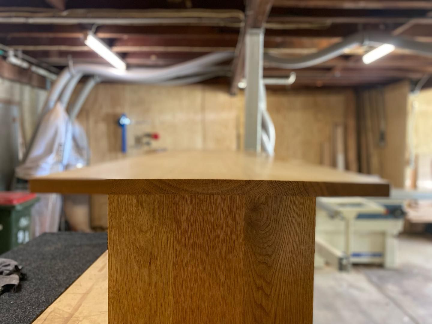 Close-up of a finished oak wood table in a workshop — BC Customs in Burrell Creek, NSW
