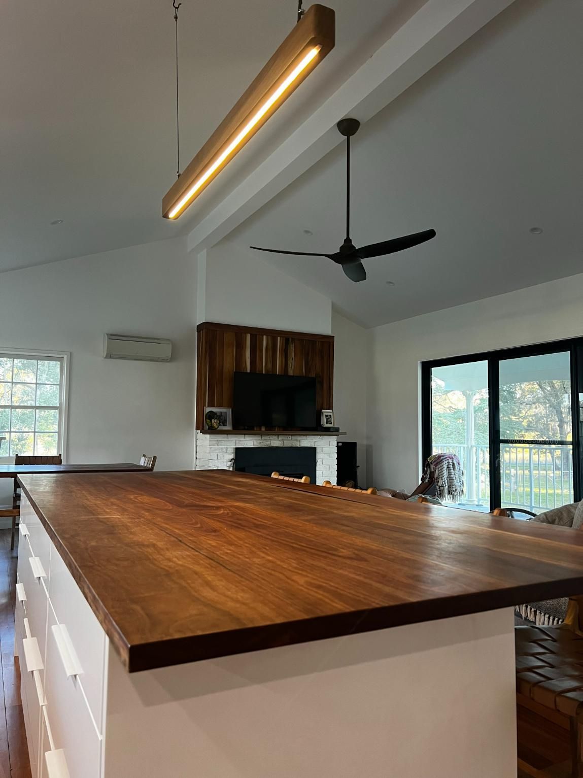 Kitchen with wooden island, pendant light, ceiling fan — BC Customs in Burrell Creek, NSW