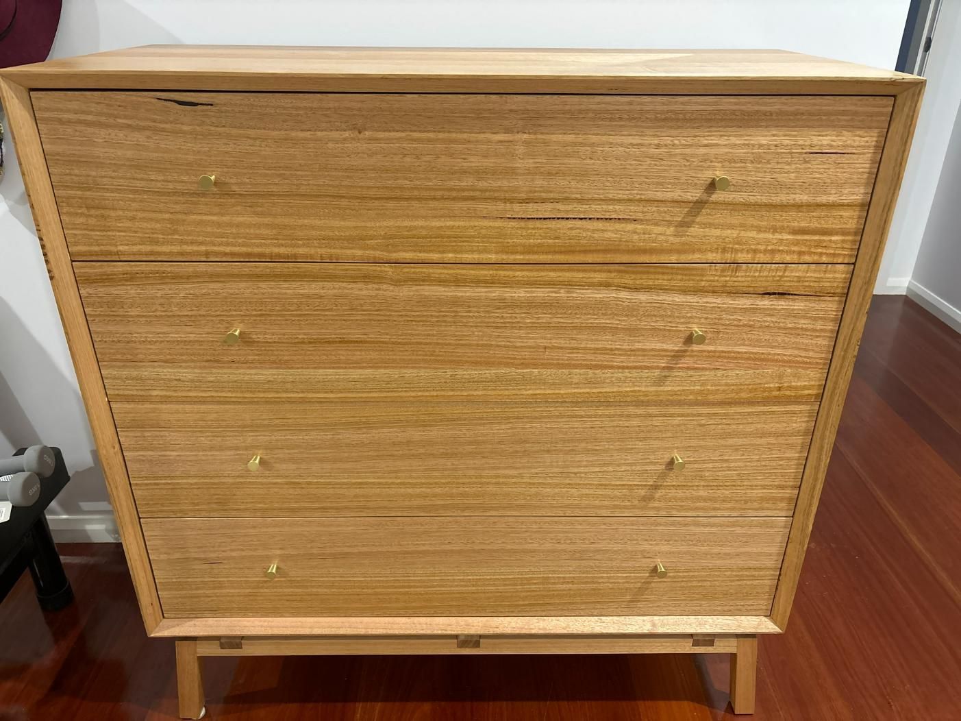 Light Brown Wooden Dresser With Three Drawers And Brass Knobs Against Dark Wood Floor — BC Customs in Newcastle, NSW