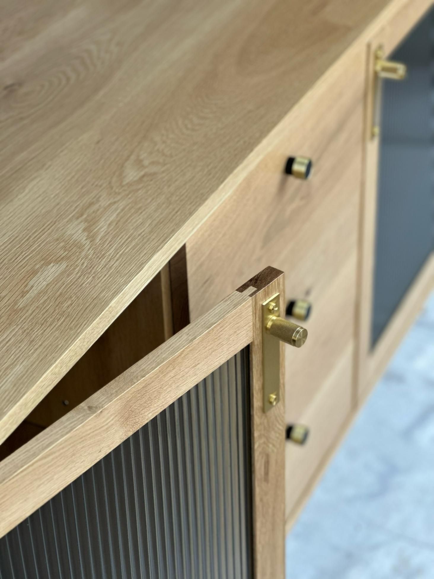 Light Wood Cabinet With Gold Hardware And Ribbed Glass Doors — BC Customs in Newcastle, NSW