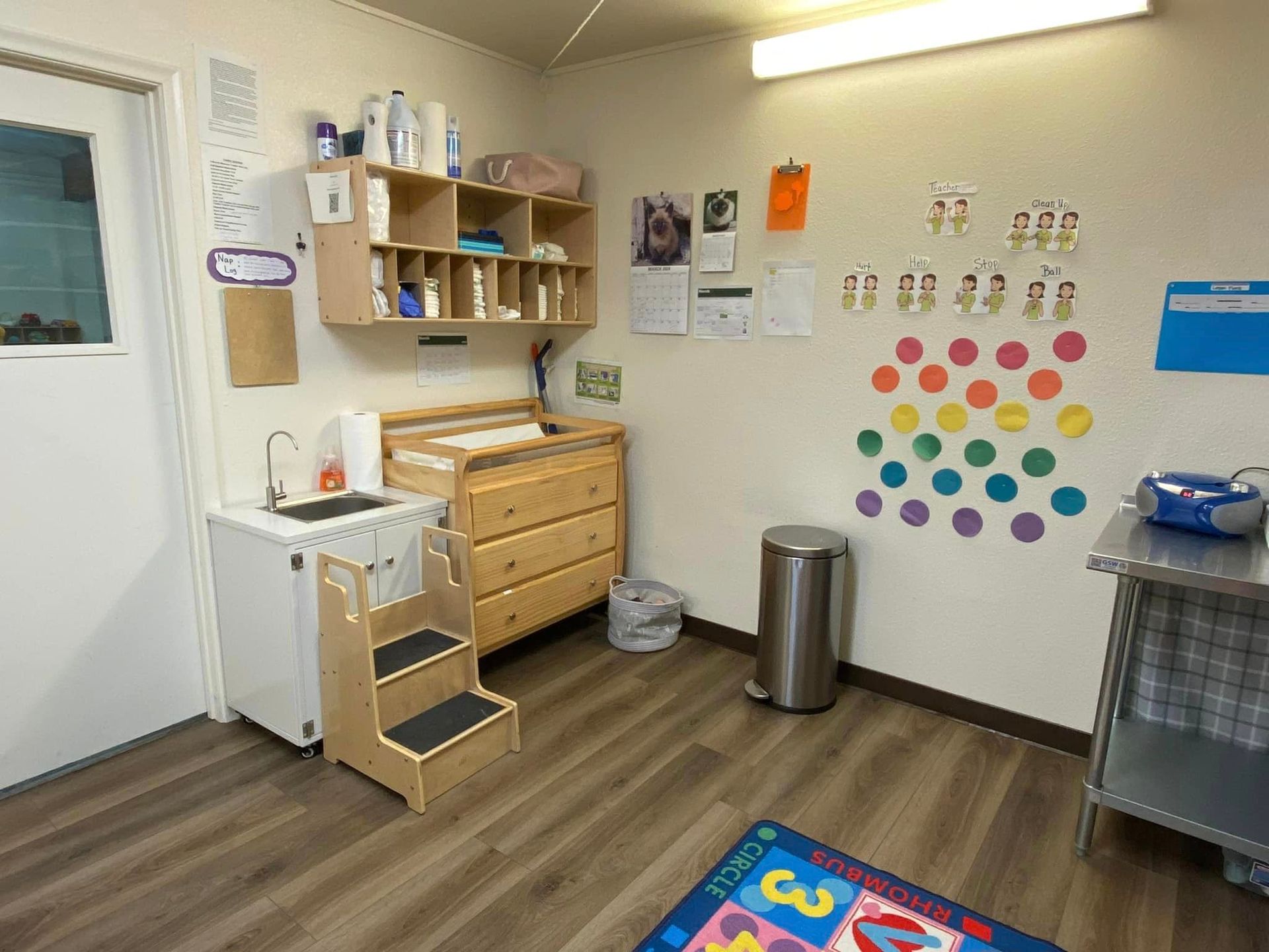 A Room with A Changing Table, Stairs, a Trash Can, and A Rug with Numbers on It – Oroville, CA – Aunt Sherrie's Preschool