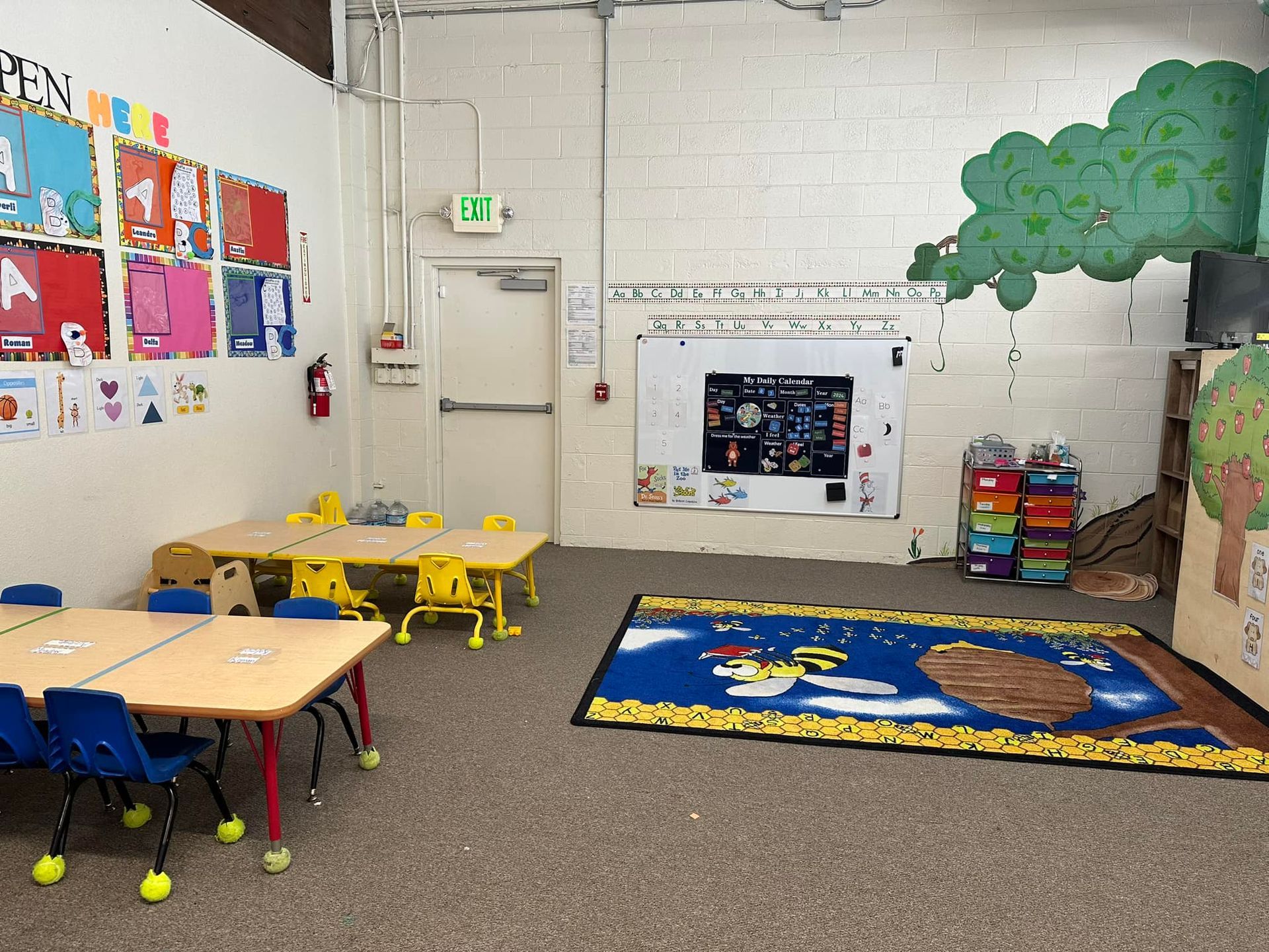 A Classroom with Tables and Chairs and A Rug on The Floor – Oroville, CA – Aunt Sherrie's Preschool