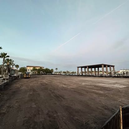 A large empty parking lot with a building in the background.