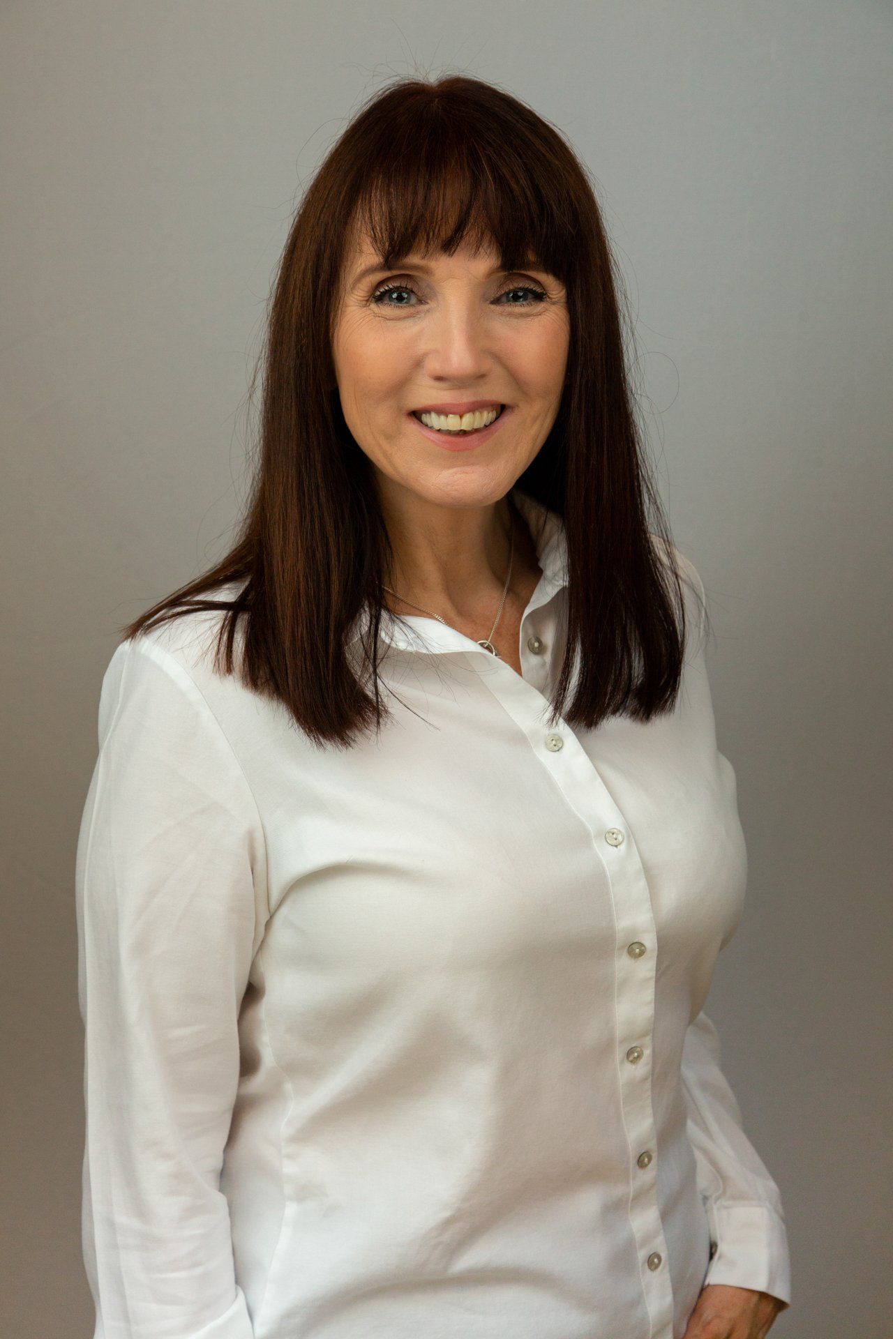 Corporate headshot in Leeds studio of a woman wearing  a white blouse