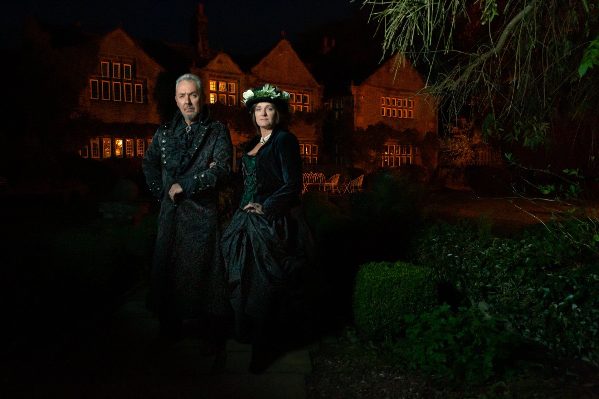 Moody portrait of gothic couple outside Holdsworth House, Halifax