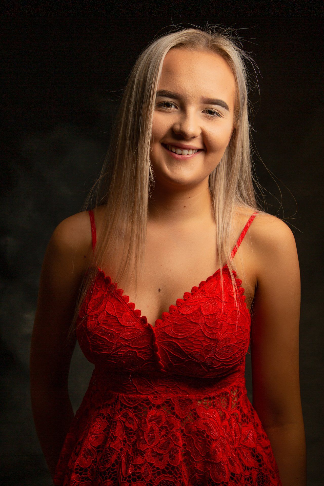 Teenager photoshoot of girl wearing red top taken in Roth Read Photography studio in Leeds