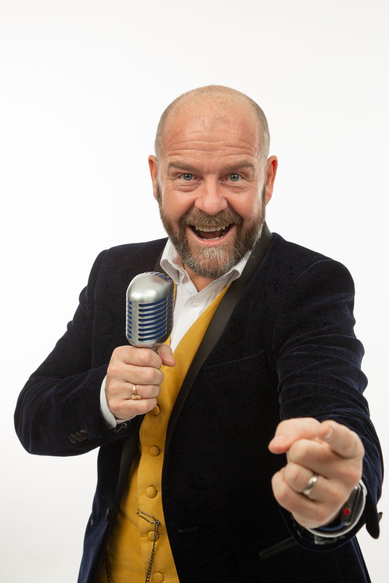 Emotipic of man wearing a yellow waistcoat and holding microphone taken in Leeds Photography Studio