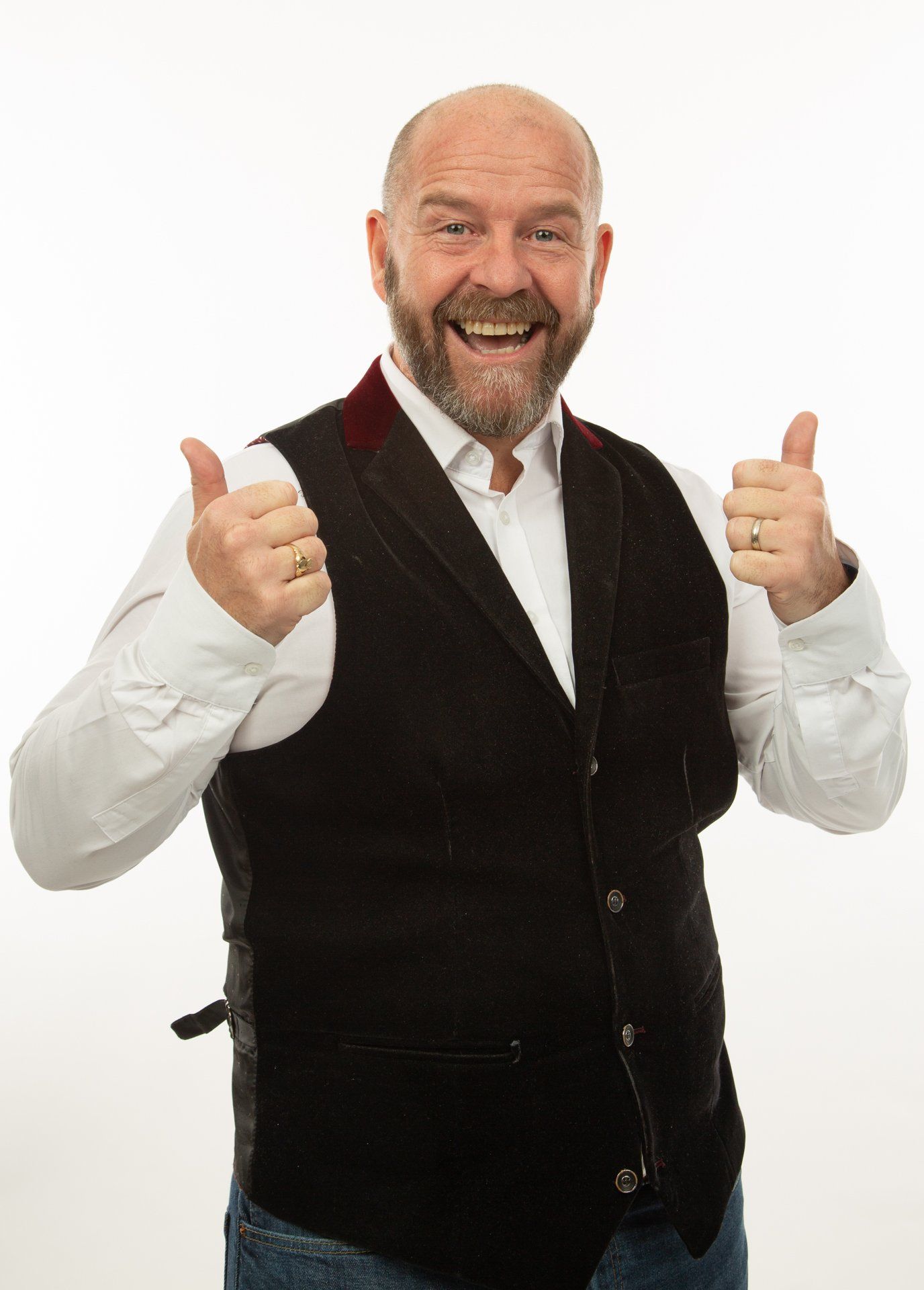 Emotipic of man wearing black waistcoat with his thumbs up taken in Leeds Photography Studio