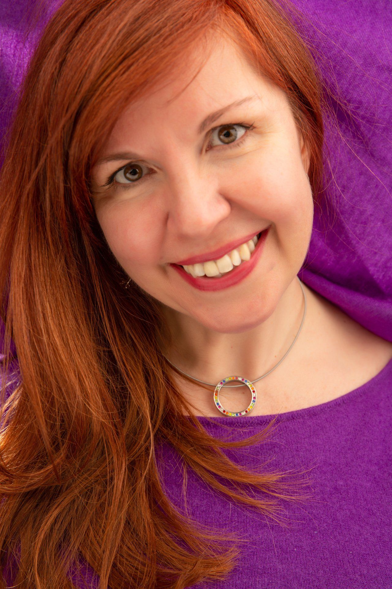 Headshot of lady wearing purple dress taken at Roth Read Photography studio Leeds