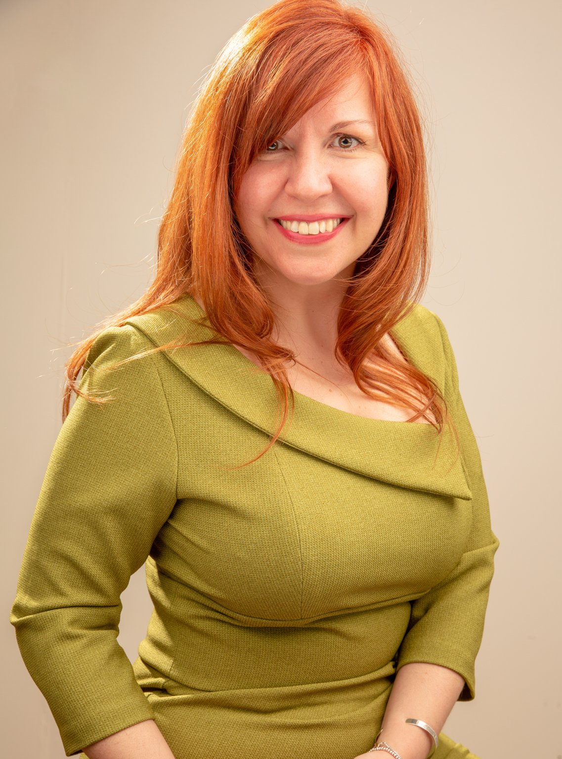Headshot of lady wearing green dress taken at Roth Read Photography studio Leeds