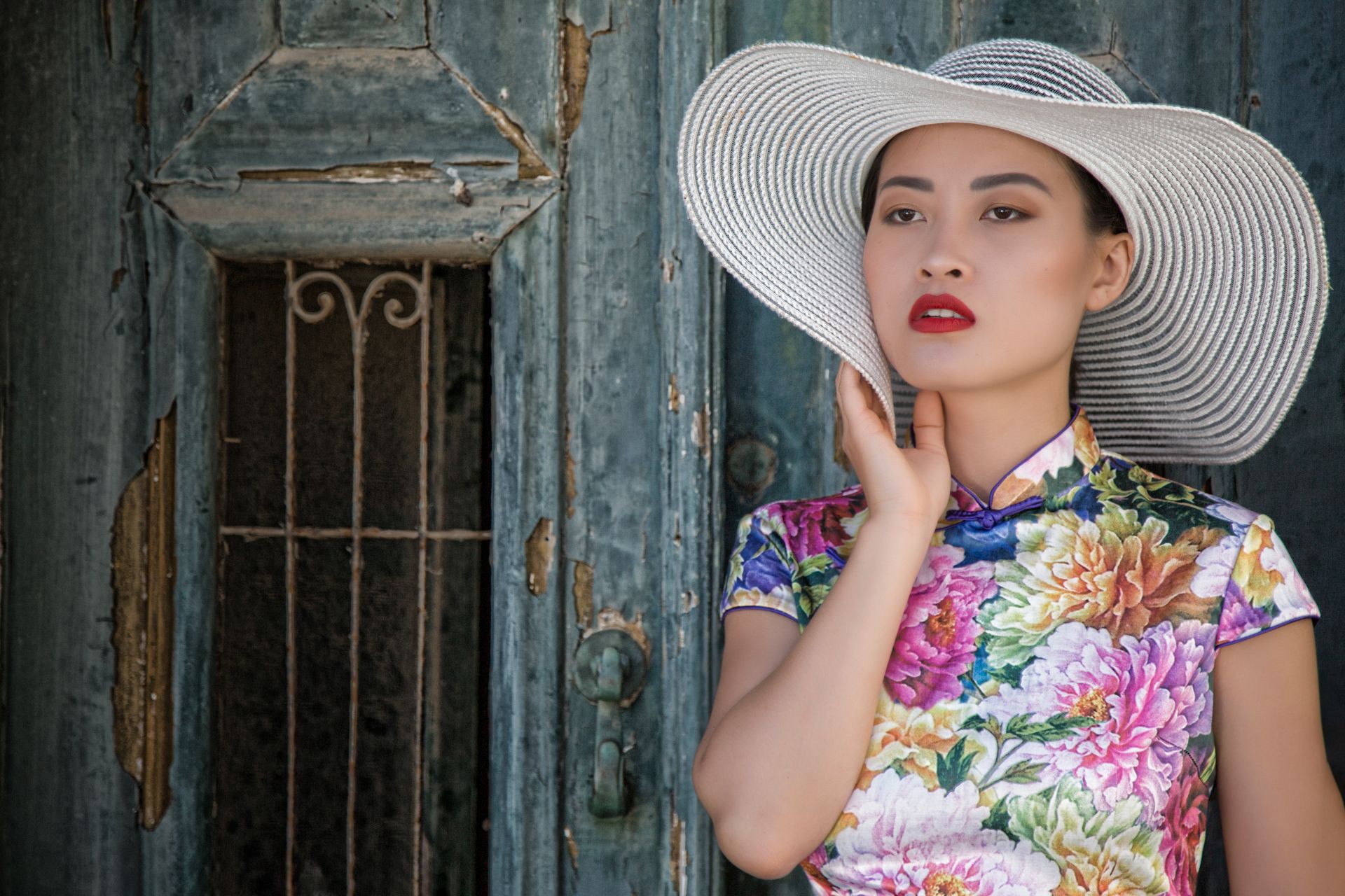 Model photoshoot Algarve girl wearing floral in front of old door.