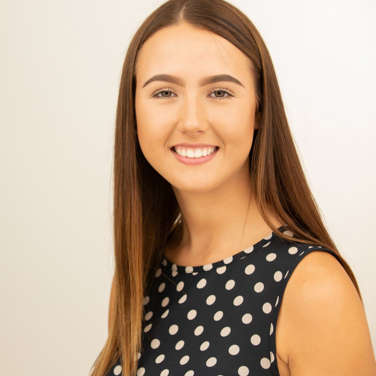 Headshot taken in Leeds photography studio of fair haired woman wearing polka dot dress