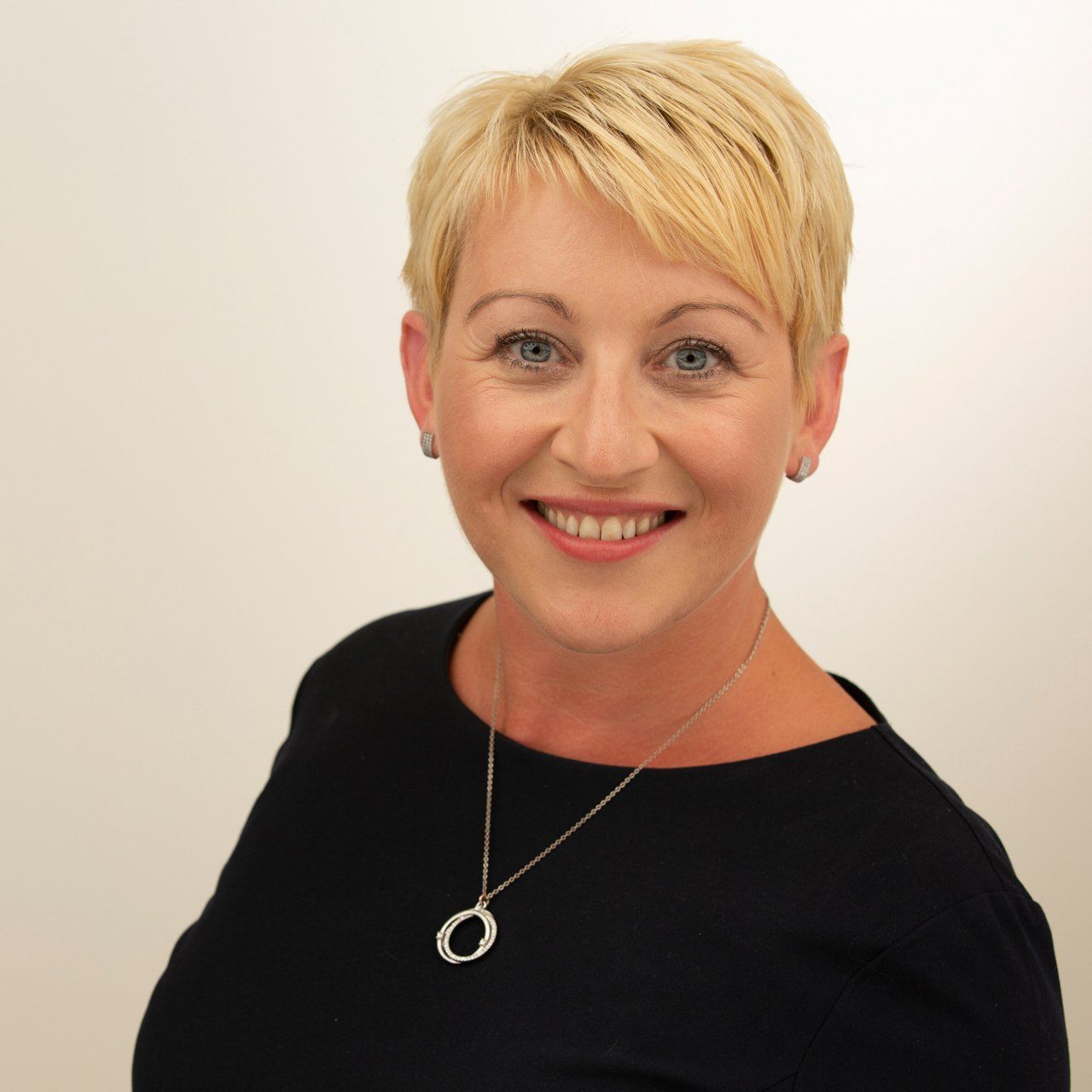 Headshot taken in Leeds photography studio of fair haired woman wearing black top