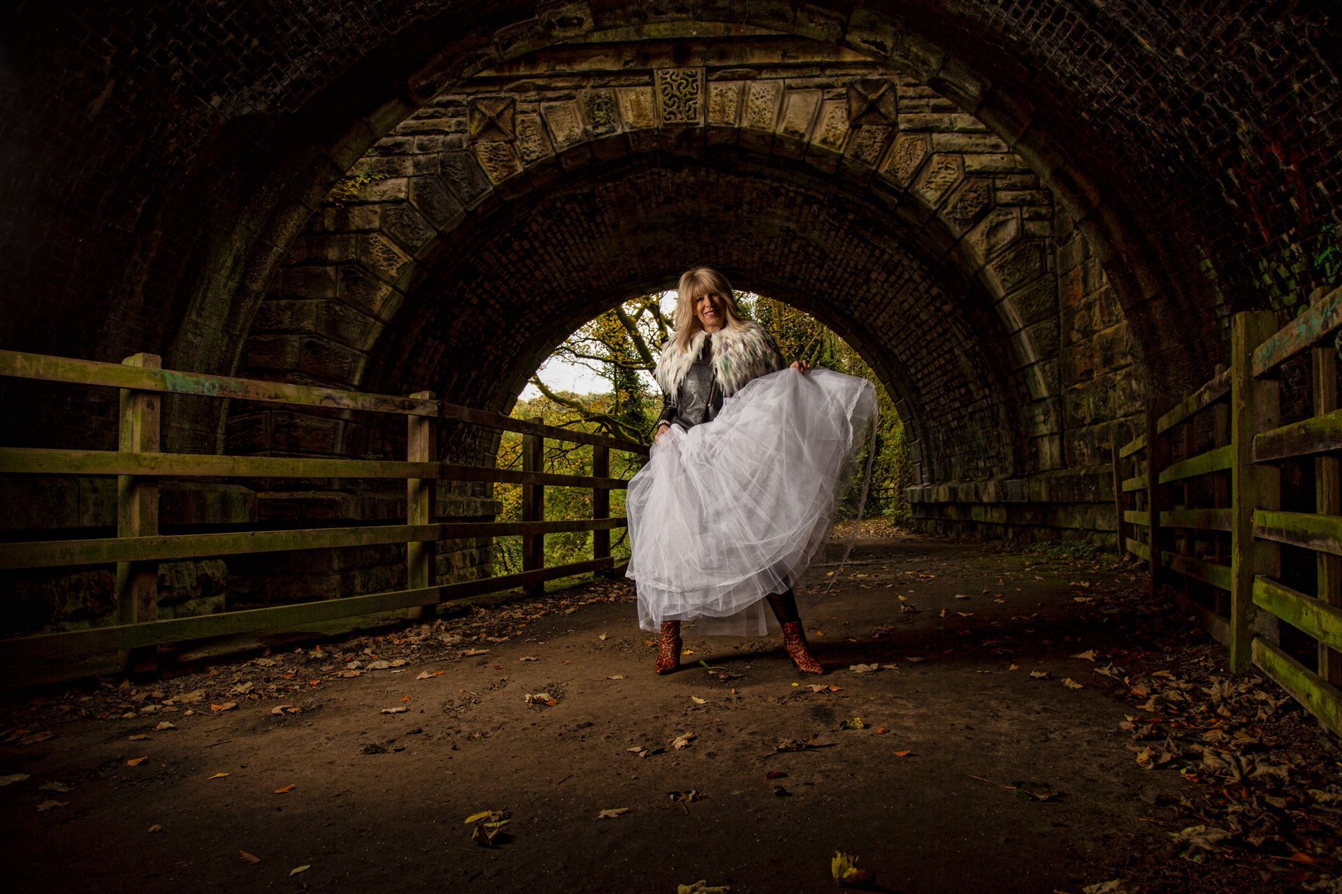 Mandy Taylor MBE wearing feathers, tulle and leather for legacy shoot under bridge at Golcar.