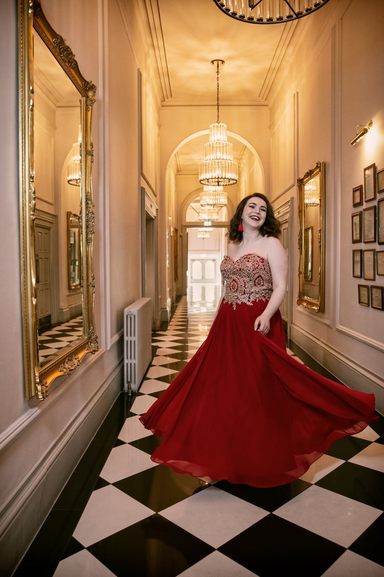 Prom photography of teenager swirling around in a deep red prom dress at The Principal Hotel, York
