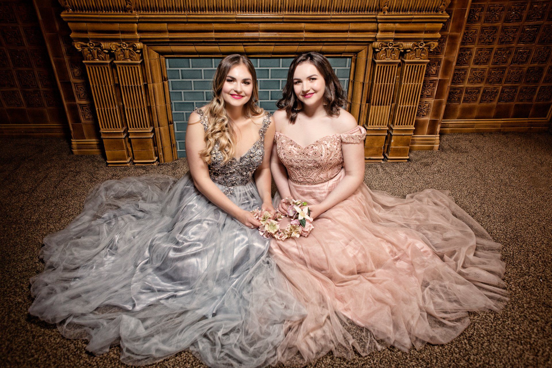 Sisters wearing beautiful grey and pink prom dresses posed on the floor of The Principal Hotel, York