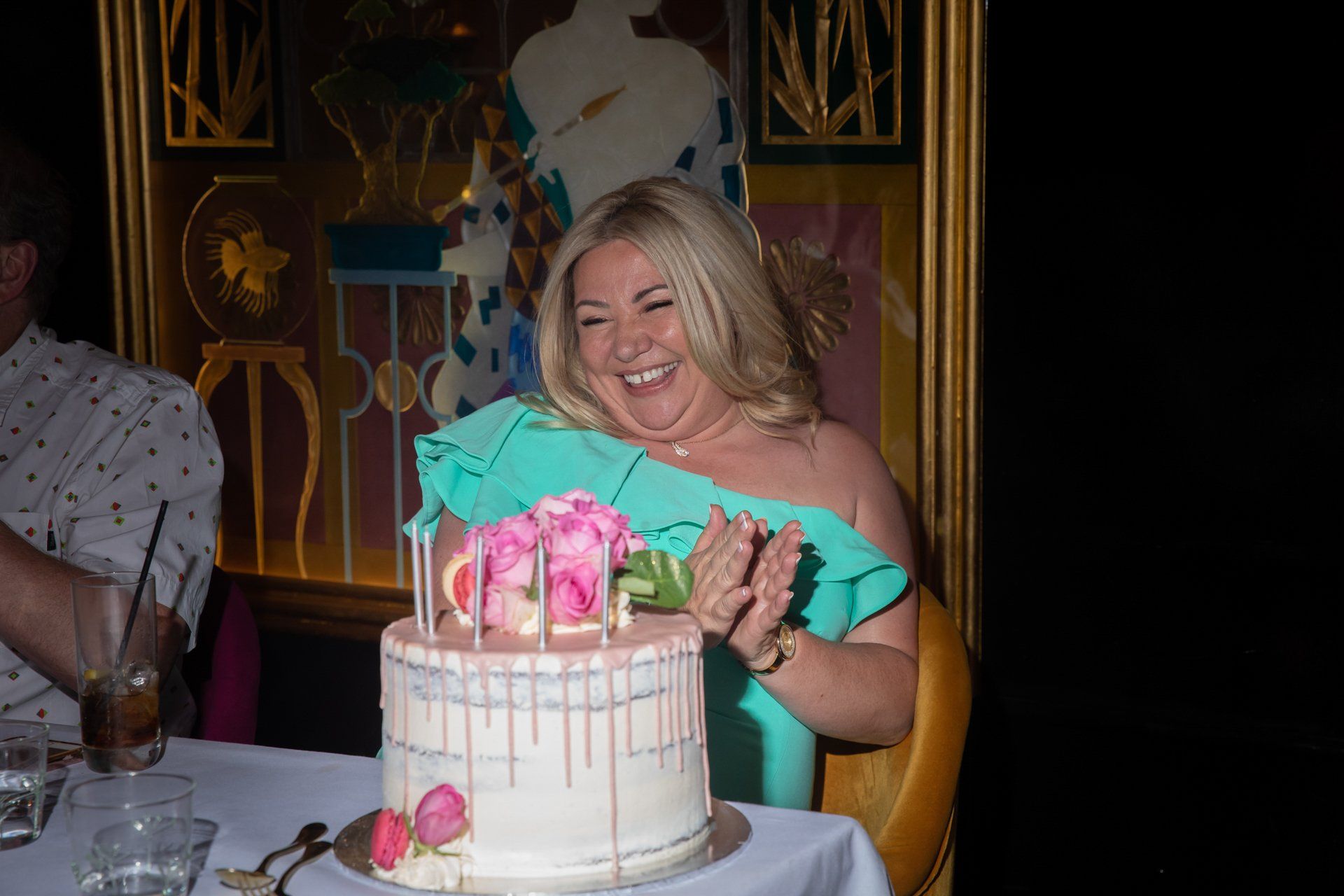 Birthday girl with pink and white cake at The Ivy Spinningfields, Manchester
