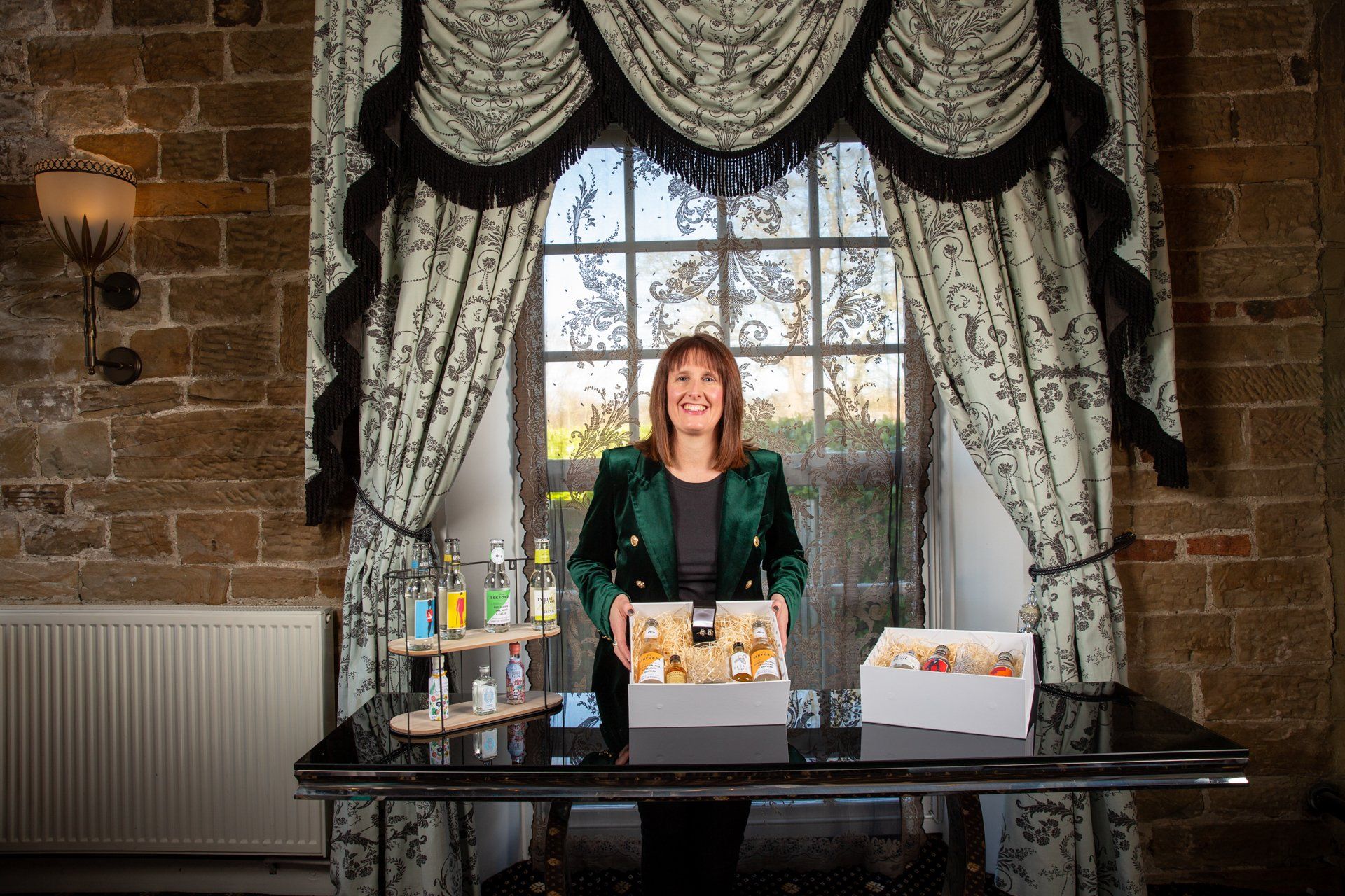 Commercial photography lady presenting gin gift boxes at Warterton Park, Wakefield