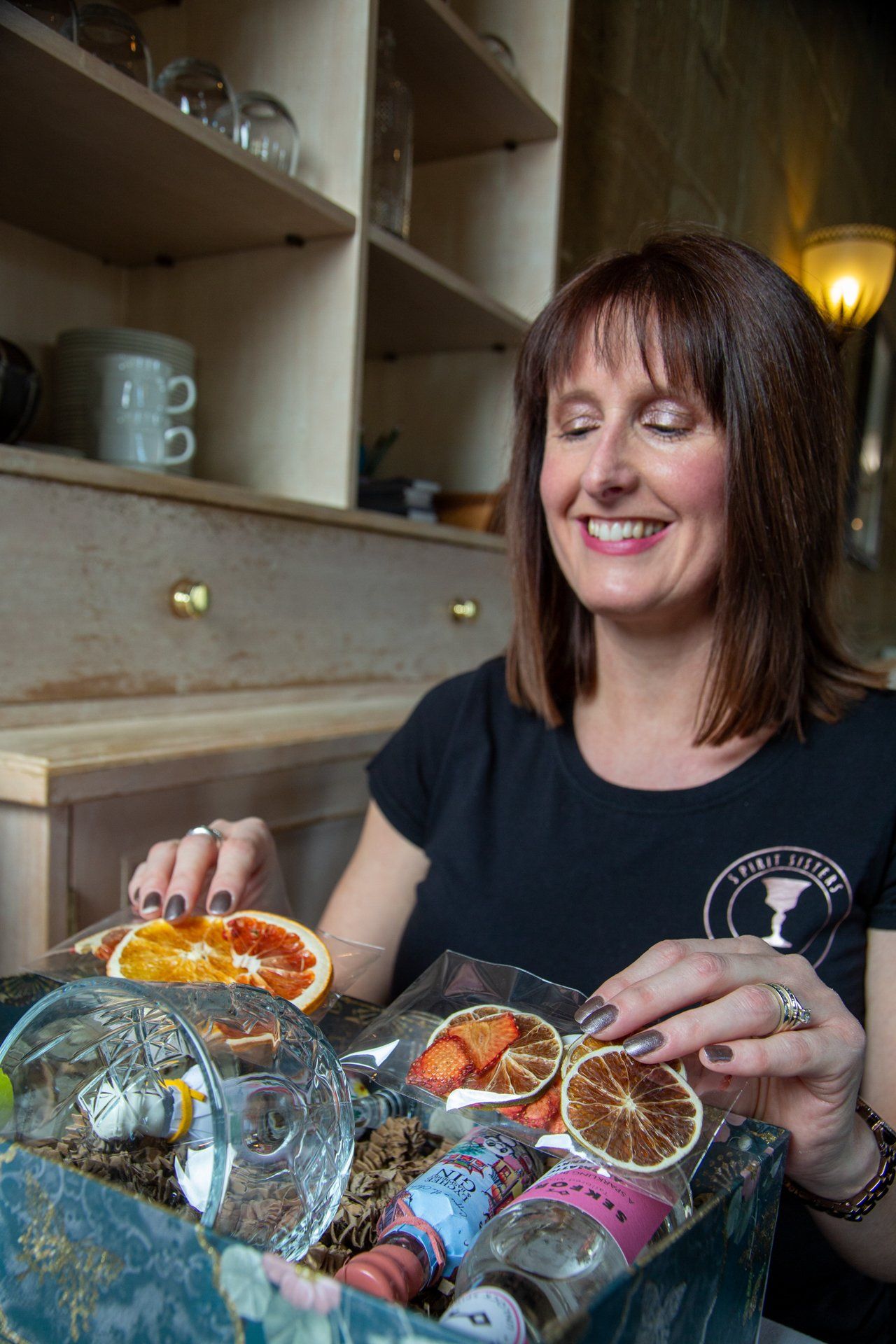 Commercial photography lady preparing gin gift boxes at Warterton Park, Wakefield