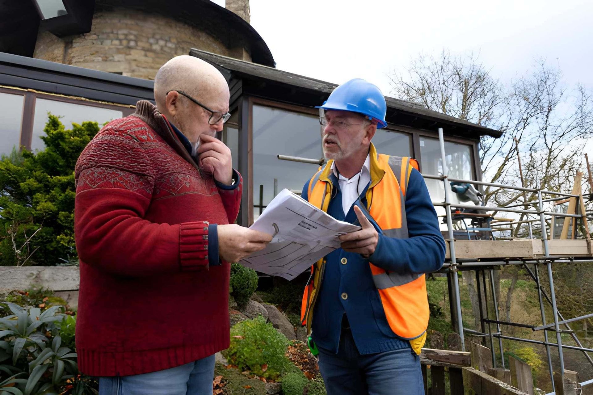 4 point inspections Port St. Lucie FL—contractor and client review building plans at renovation site.