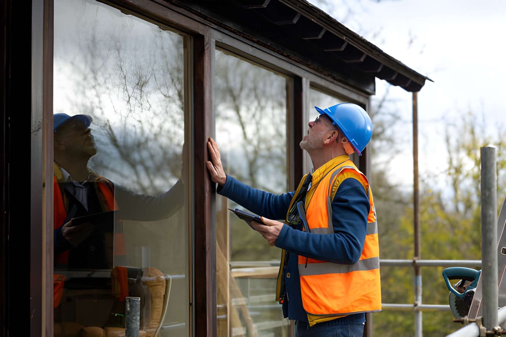 Home inspection West Palm Beach inspector documenting window condition on tablet