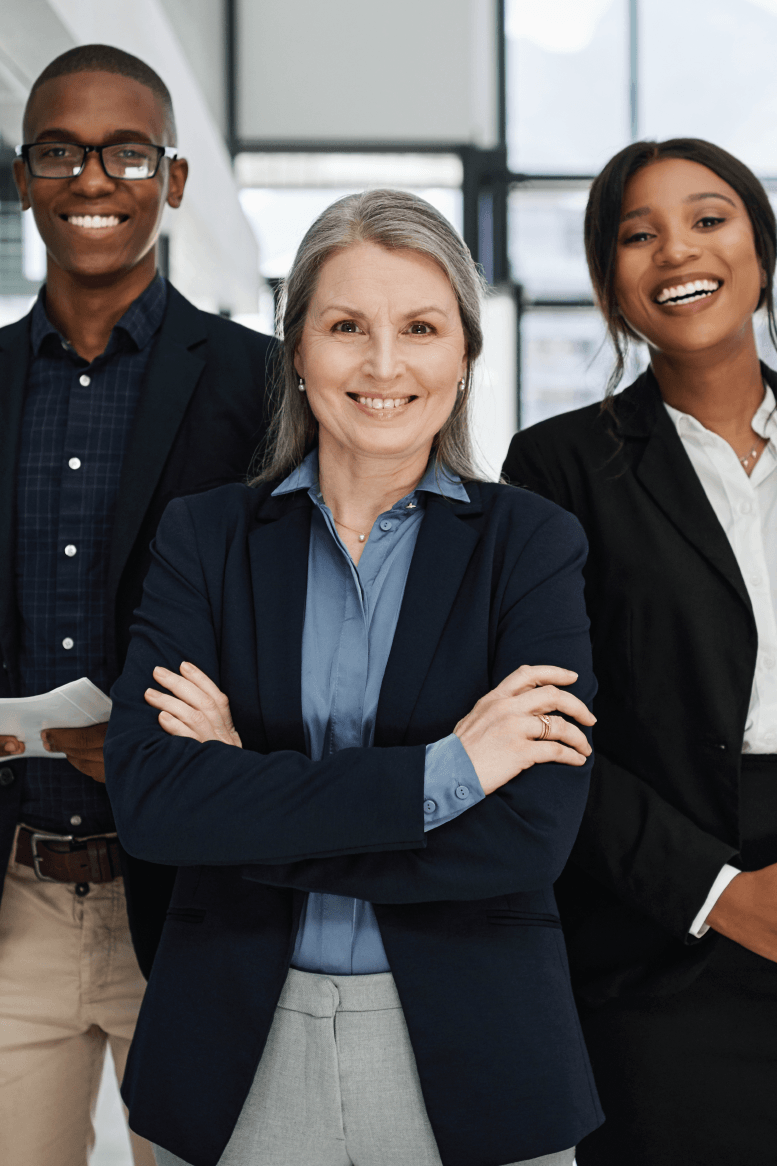 A group of business people standing next to each other with their arms crossed and smiling.